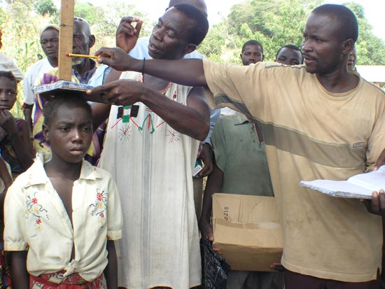 Girl is measured to determine proper dosage of medication.