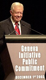 President Carter addresses participants in the Geneva Initiative public commitment event.