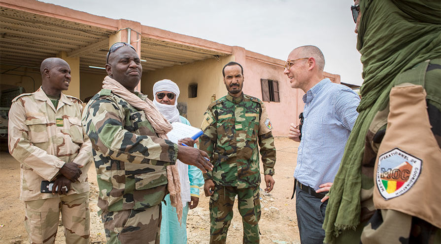 John Goodman, an associate director in the Carter Center’s Conflict Resolution Program, talks with members of Kidal’s MOC, a joint military unit. Commanders say they’re dealing with a number of problems, many stemming from a lack of supplies and manpower. 