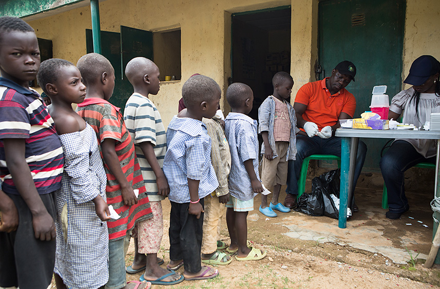 A sample of schoolchildren line up for a quick blood test in Plateau state, Nigeria. 