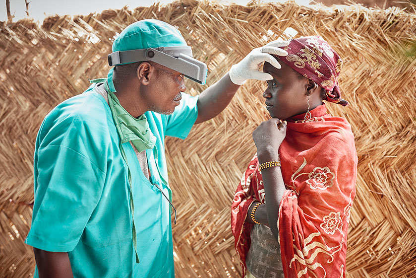 A doctor in Niger examines a young patient for eye damage associated with trichiasis.