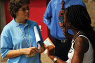 Karin Ryan (left) listens to a voter explain the trouble she's had with her registration card during the 2006 elections in the Democratic Republic of the Congo.