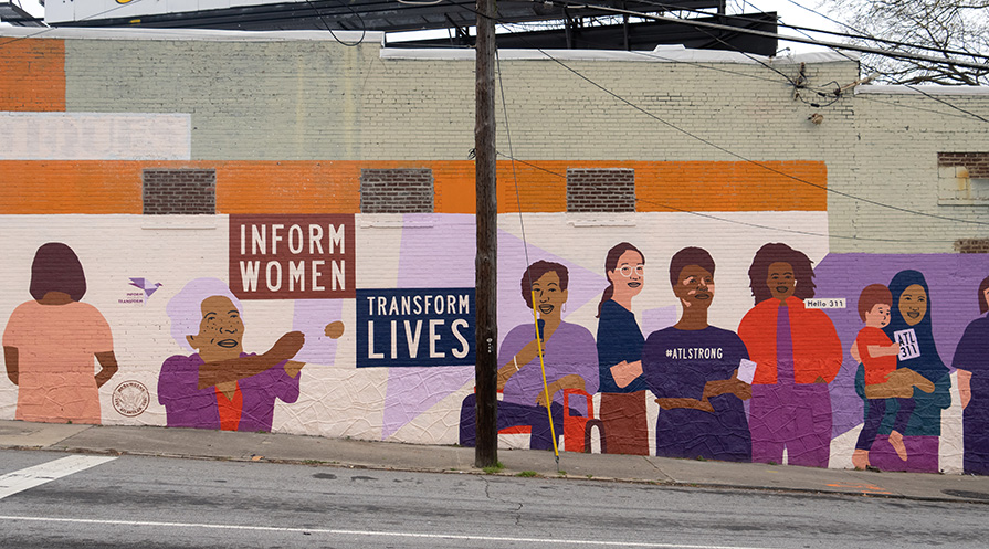 A mural showing women accessing information