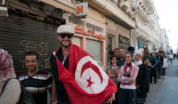 Mid-morning in downtown Tunis, hundreds queued in line proudly to vote, many for the first time in their lives.