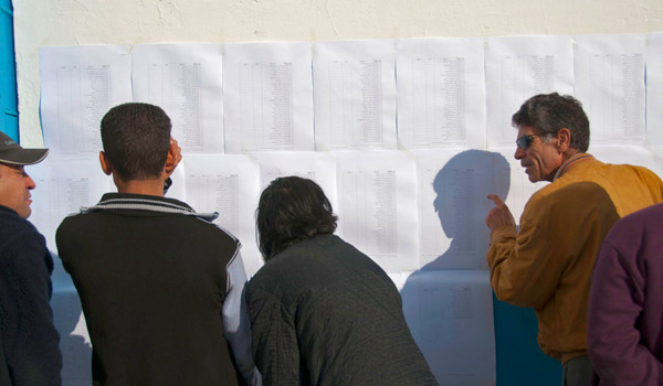People look for their names on the voter list in downtown Tunis.