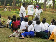 Ugandan community members gather for health education about river blindness.