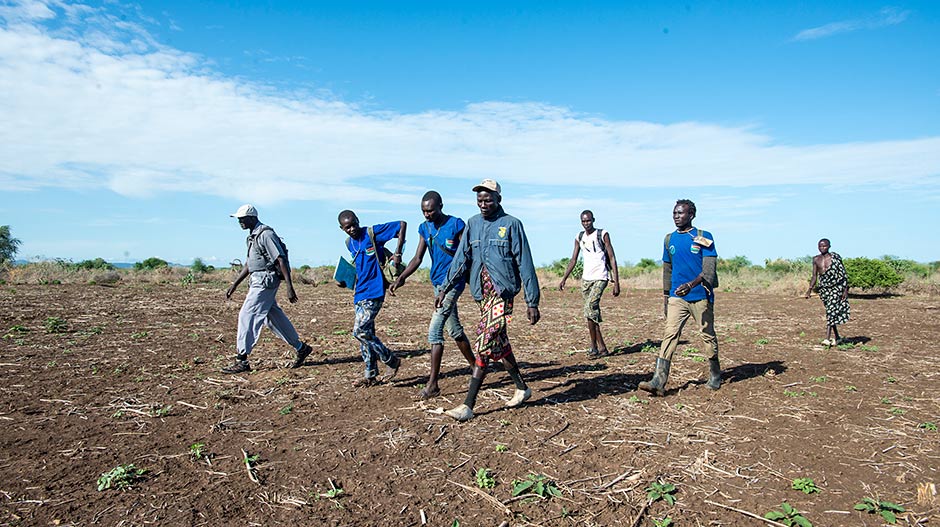 Photo of a surveillance team from the South Sudan Guinea Worm Eradication Program, led by Makoy Samuel Yibi (far left), exploring an area of Eastern Equatoria state.