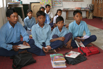 Nepalese students read about Kalu, a boy who teaches his family the importance of face-washing.
