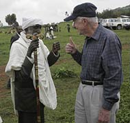 Former President Jimmy Carter gives a 'thumbs up' to a villager who has had an operation to repair damage to his eyes caused by trachoma.