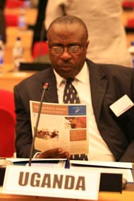 Dr. Richard Nduhuura, the state minister of health of Uganda reads about the achievements of the Ethiopia Public Health Training Initiative.