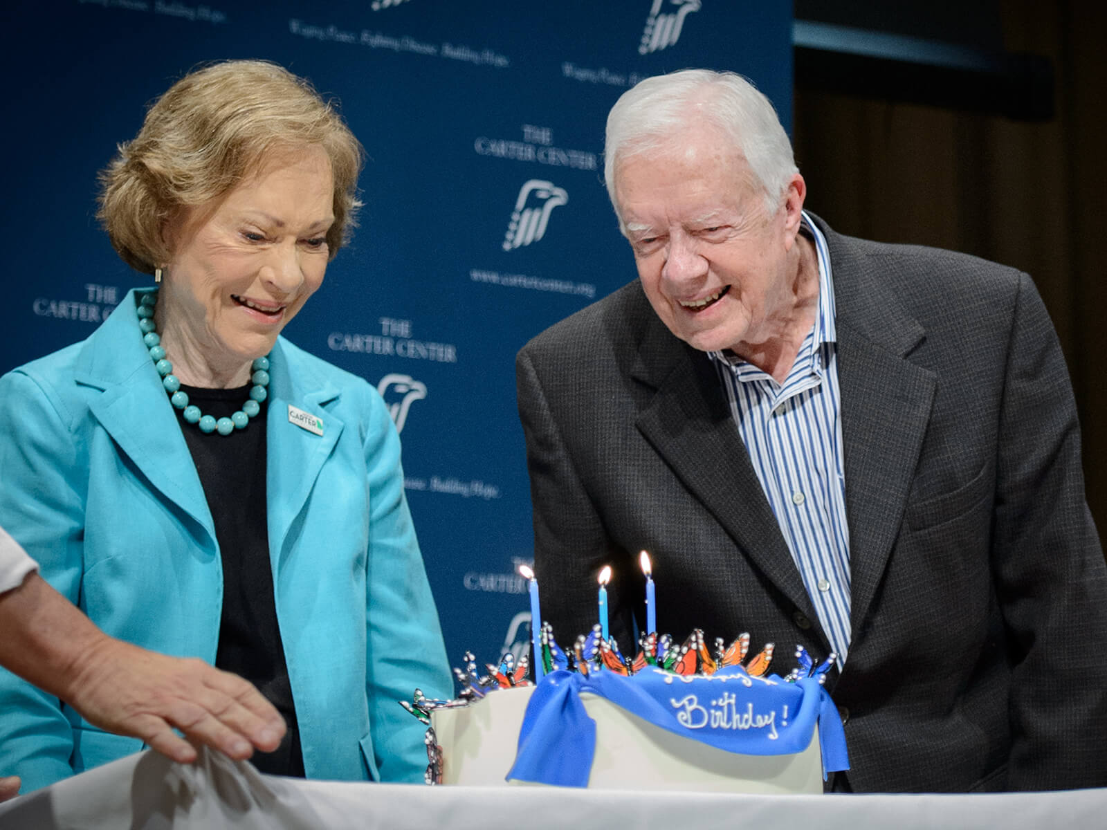 Graphic of President Carter blowing out candles on his 90th birthday.