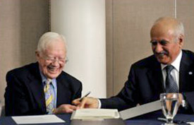 President Carter and OFID Director General Suleiman Jasir Al-Herbish sign grant agreements