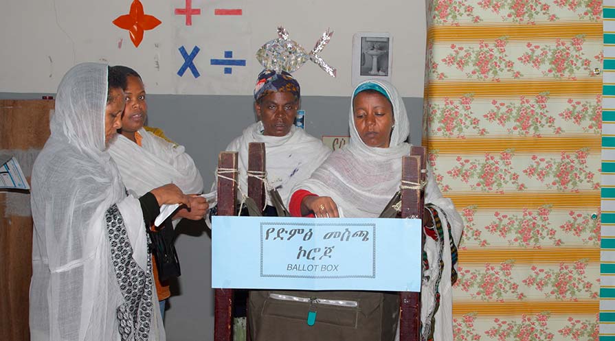 Photo of four Ethiopian women at a ballot box.