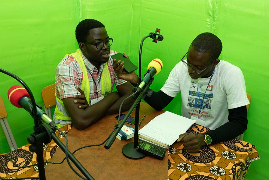 Two men participate in a podcast interview.