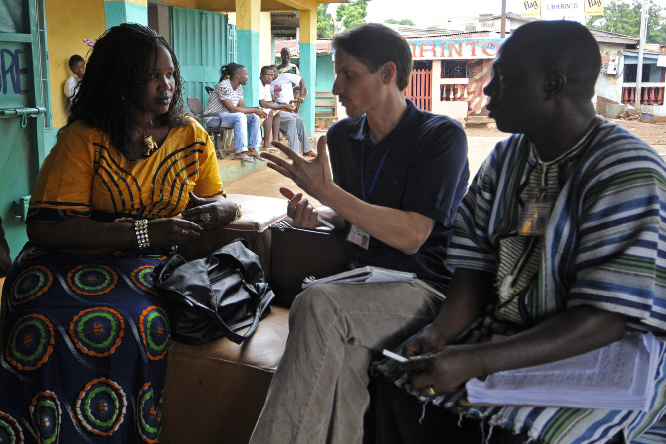 Carter Center observers talk with a voter in Lakome, Guinea.