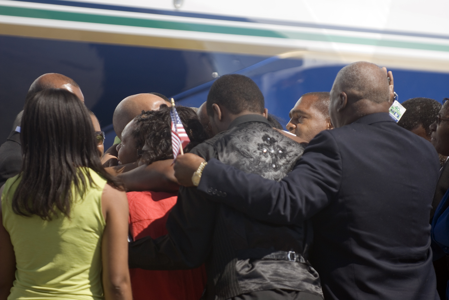 Aijalon Gomes is embraced by his family after arriving in Boston.