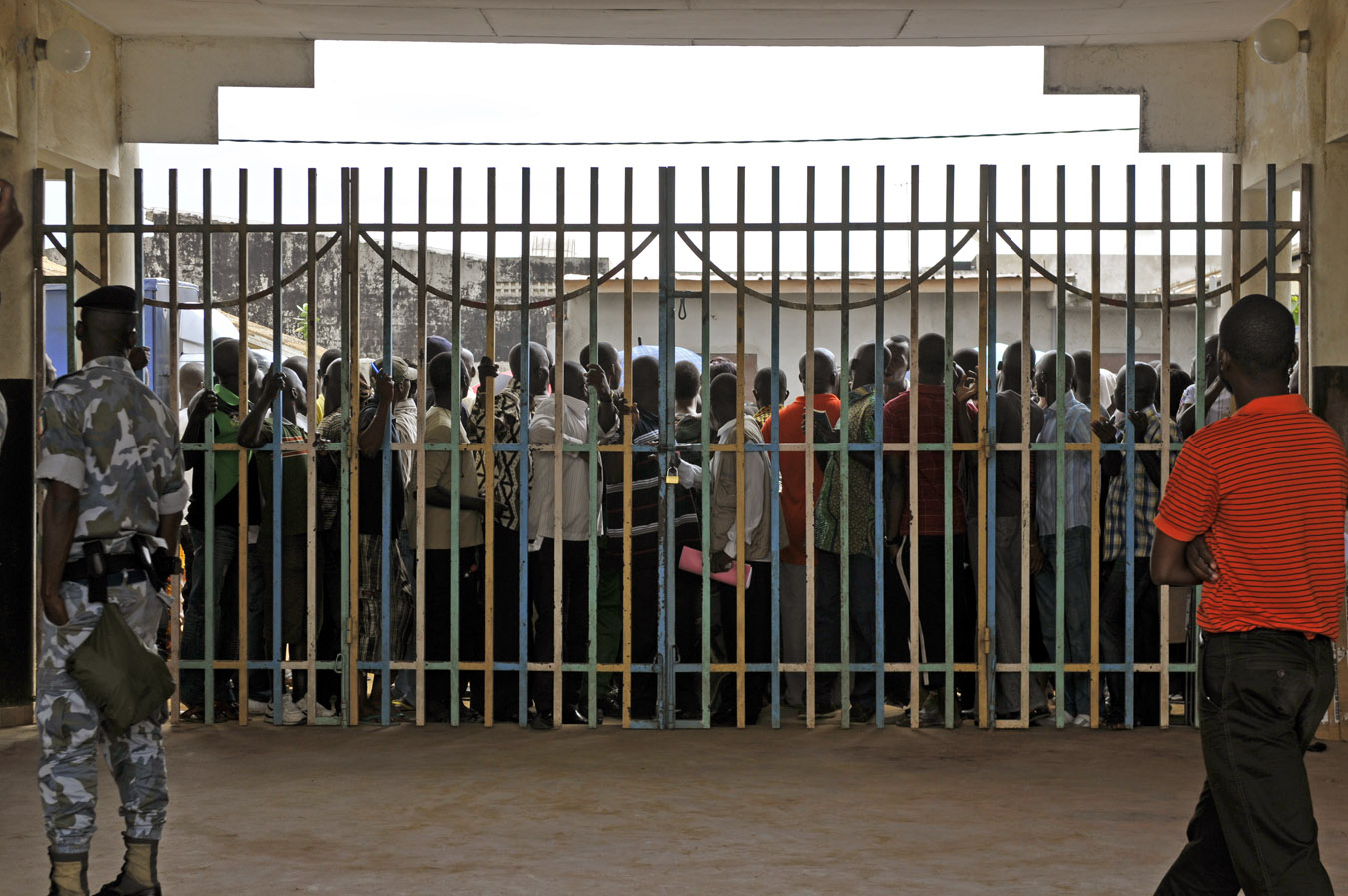 Voters wait outside closed gates in Cote d'Ivoire