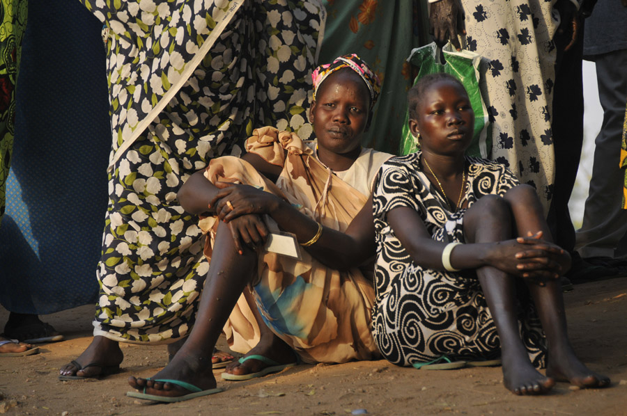 Two women wait for voting to begin in Lologa Market, Juba.