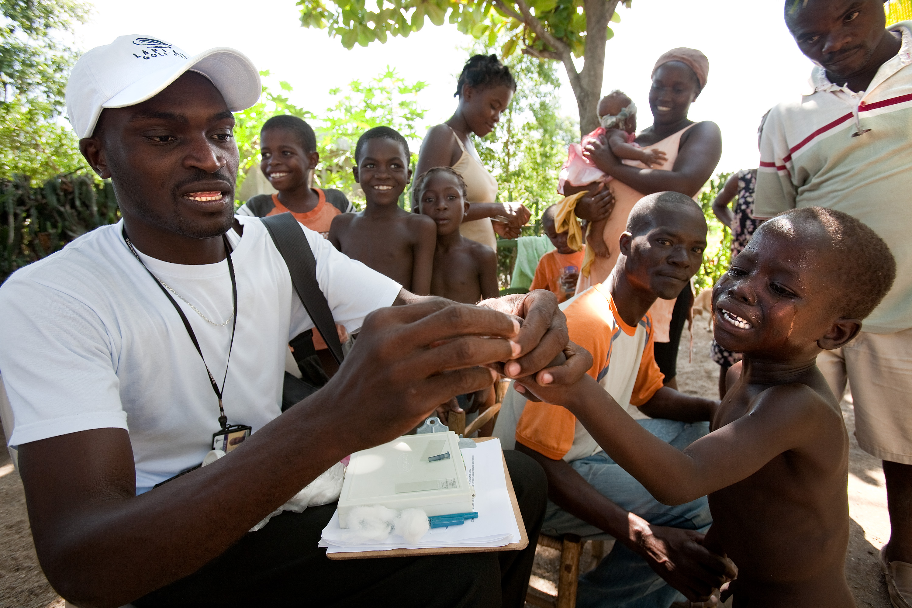 Haitian health worker Jonel Mompremier pricks the finger of a young child to test his blood for malaria parasites in Ouanaminthe, Haiti, October 6th, 2009. The efforts of The Bi-National Malaria and Lympathic Filariasis Project have increased malaria surveillance and treatment in both Dominican Republic and Haiti. "The most important thing we can do is eliminate malaria," Mompremier says. "I'm happy to contribute to the solution."