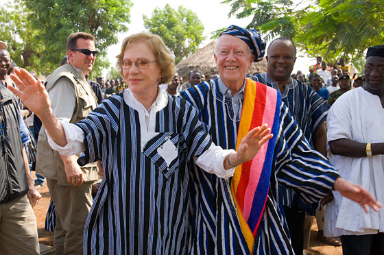 Former U.S. President Jimmy Carter and former First Lady Rosalynn Carter wear traditional Ghanaian attire, a gift from the chief of Tingoli village in northern Ghana. The Carters visited the village Feb. 8, 2007, as part of a two-week health tour of remote African villages. (Photo: L. Gubb/ The Carter Center)