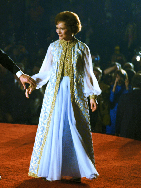 Photo of Rosalynn Carter wearing a light blue ball gown with gold trim and bodice.