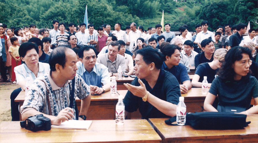 Dr. Yawei Liu (left) and other Carter Center delegates wait in the observation row at a village election in China’s Dehua County, Fujian Province on Aug. 2, 2000. (Photo: The Carter Center)