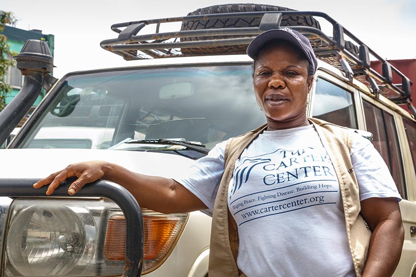 Potential puts oil in a Carter Center vehicle during a trip to Buchanan, where staff were helping lead a training session for women in Grand Bassa County.