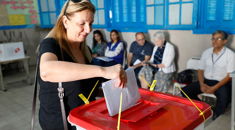 A voter casts her ballot in Tunisia. A