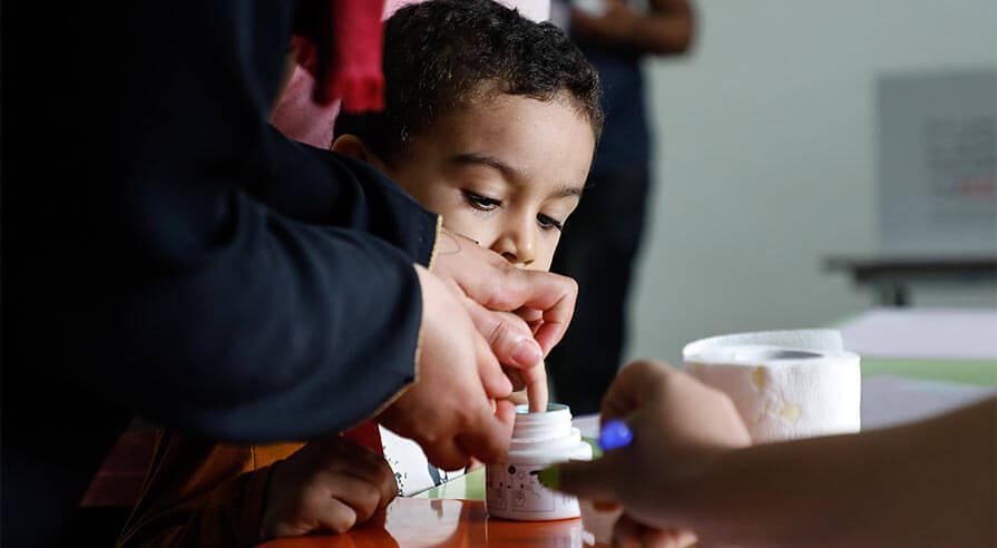 To make them feel like part of the process, children can have their fingers inked as well.