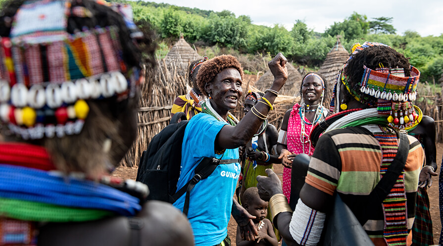 Carter Center ambassador Regina Natube leads a lively song and dance to spread the word about cash rewards for reporting possible Guinea worm cases in South Sudan.   