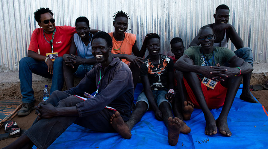 Obang Adhom, front left, relaxes with members of his Abate crew on the Mulé commercial farm in Ethiopia’s Gambella region. They do the tough work of measuring and treating the farm’s 81 ponds on a rotating 28-day cycle to help eliminate Guinea worm disease.