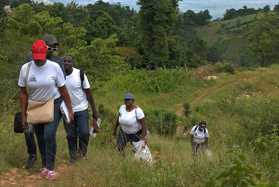 Public health agents traverse the hills of rural Haiti in search of households with children to test for signs of malaria and lymphatic filariasis.