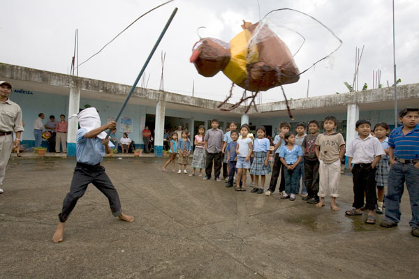 A Guatemalan boy tries his luck at a piñata.