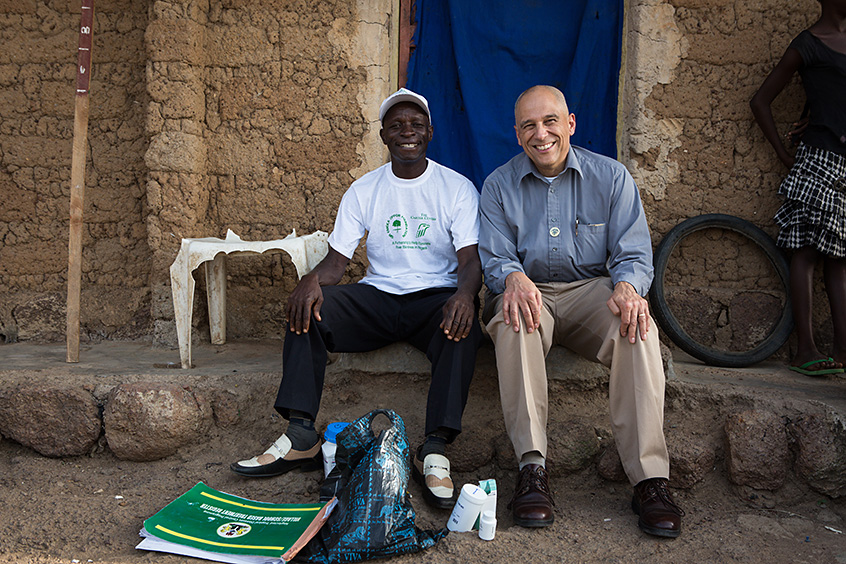 Dr. Dean Sienko (right), vice president for health programs, visits with Danladi Atinye, a volunteer community drug distributor in Plateau state, Nigeria.