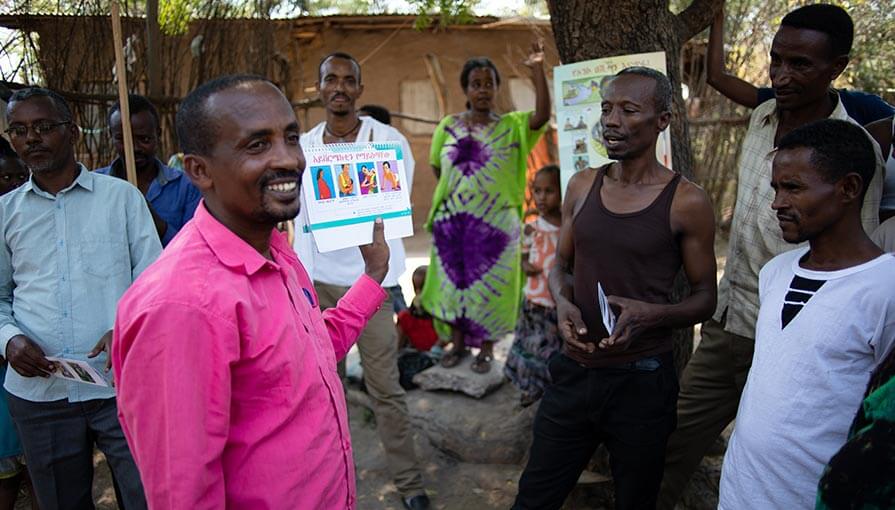 Volunteer community-directed distributor Abeje Ulondimu delivers health education to Gambella Town’s Kebele 5 neighborhood during a mass drug administration event in Ethiopia.