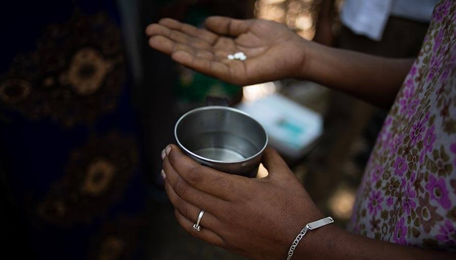 A woman who lives in the Kebele 5 neighborhood of Gambella Town, Ethiopia, holds a dose of Mectizan tablets, distributed for the elimination of river blindness. 