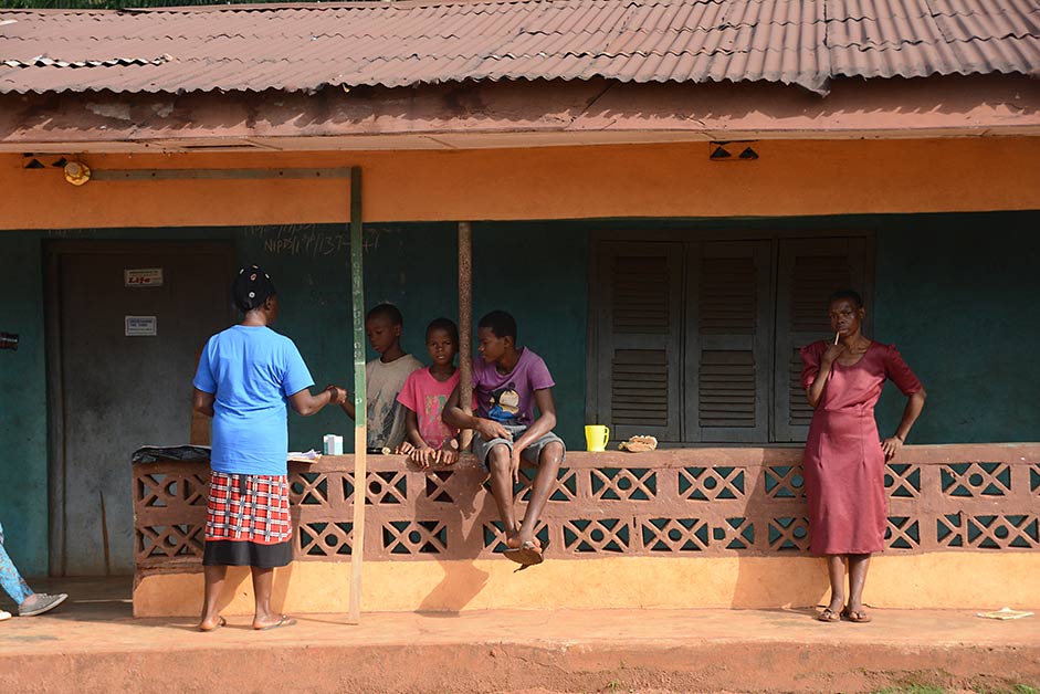 Orji stops at one household to provide treatments to several young people. (Photo: The Carter Center)