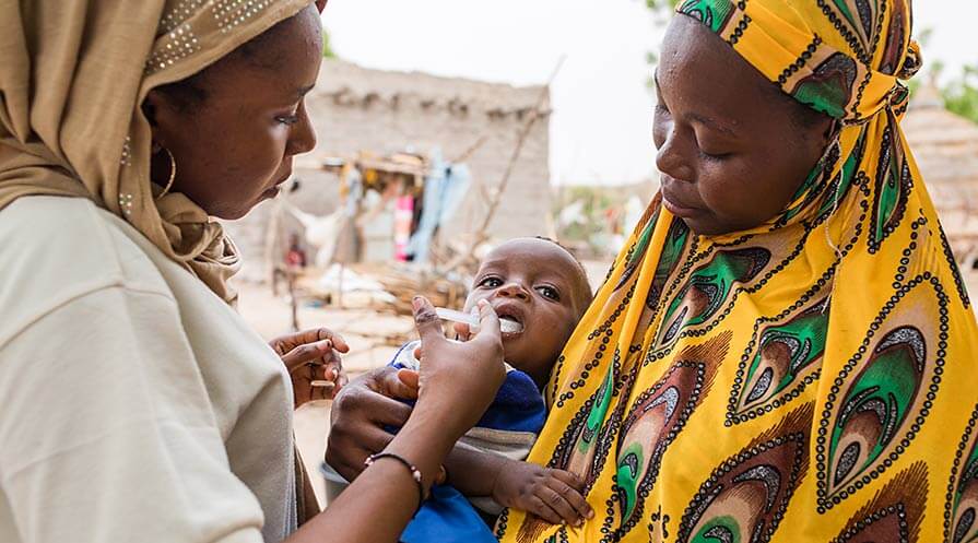 A mother and baby in a village in Niger participate in a study analyzing the long-term effects of mass administration of the antibiotic drug azithromycin.