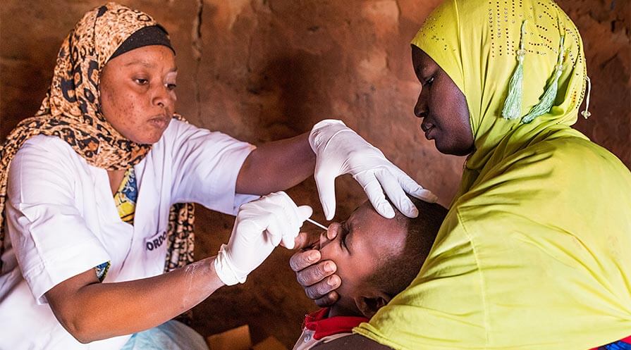 A mother and baby in a village in Niger participate in a study analyzing the long-term effects of mass administration of the antibiotic drug azithromycin.