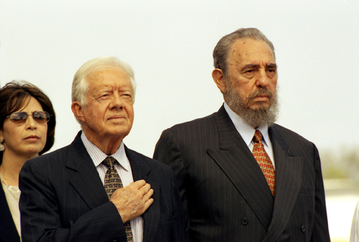President Carter listens to the U.S. national anthem during the arrival ceremony of his historic visit to Cuba in May 2002 at the invitation of Fidel Castro.