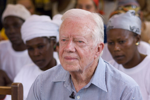 Former U.S. President Jimmy Carter listens to community members talk about an outbreak of Guinea worm in Savelugu, Ghana.