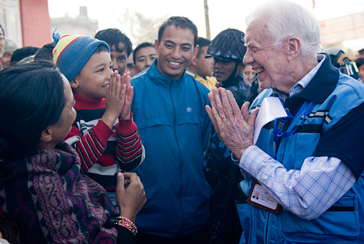 Former U.S. President Jimmy Carter greets a Nepalese boy in Kathmandu. The Carter Center monitored Nepal's Nov. 19, 2013, constituent assembly election, sending 66 observers from 31 countries to visit 336 polling centers in 31 districts.