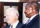 Sudan President Omar Al-Bashir (left) shakes the hand of Uganda President Yoweri Museveni as Kenya President Daniel arap Moi and President Carter look on.
