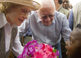 A young Nigerian girl presents former First Lady Rosalynn Carter with flowers.