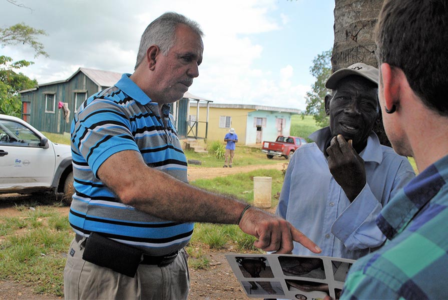  Dr. Manuel Gonzales discusses health care with Andrean Bon, 69, a native of Haiti who has lived in the Dominican Republic for 35 years. Bon, who cuts sugar cane for a living, has endured years with an enlarged groin, a debilitating and painful condition caused by lymphatic filariasis.(Photo: The Carter Center)