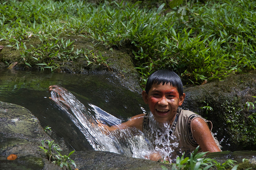 Yanomami boy in a river