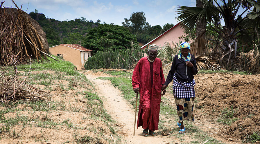 Adonku Ayina (left) walks with his wife Saratu, in Kisanchi, Plateau State, Nigeria. 