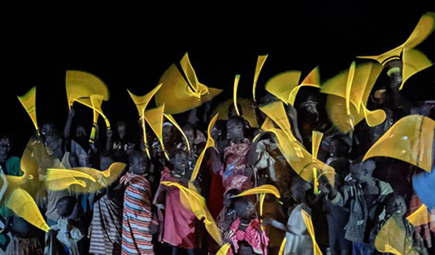People celebrate with lights in Yei Village, South Sudan.
