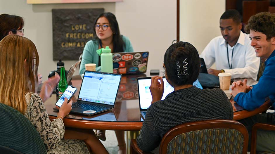 Interns working at round table.