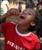 A young Ethiopian girl takes the Pfizer-donated antibiotic needed to treat her trachoma infection.